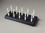 Black FswStudio bassoon reed drying rack with ten removable Dorn-style pins