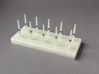 Cream FswStudio bassoon reed drying rack with ten removable Dorn-style pins
