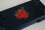 Close-up of the hand-painted red roses on a navy FswStudio bassoon reed case in the Rose design
