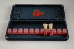 Open FswStudio Rose bassoon reed case for 10 reeds with painted roses on the lid and bassoon reeds in a pink strap