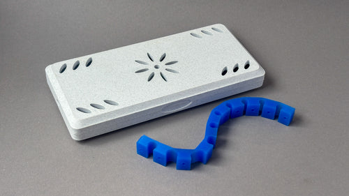 white marble reed case for 10 bassoon reeds with a silicon strap