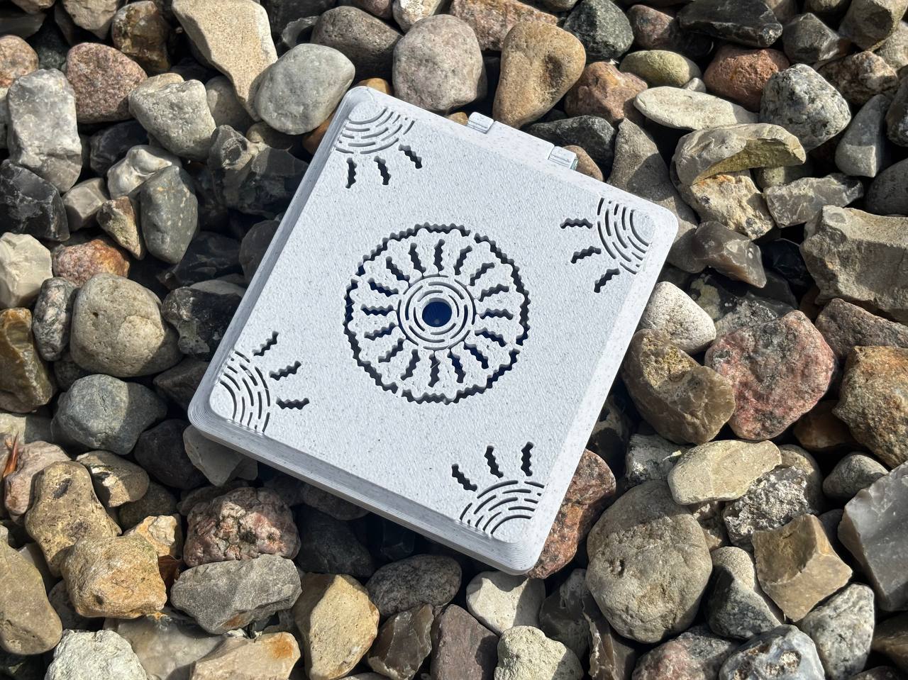 The FswStudio Combined Reed Case for 5 Oboe and 3 English Horn Reeds is a handmade white square case with black circular and corner patterns, shown resting on assorted stones—ideal for storing your oboe or English horn reeds.